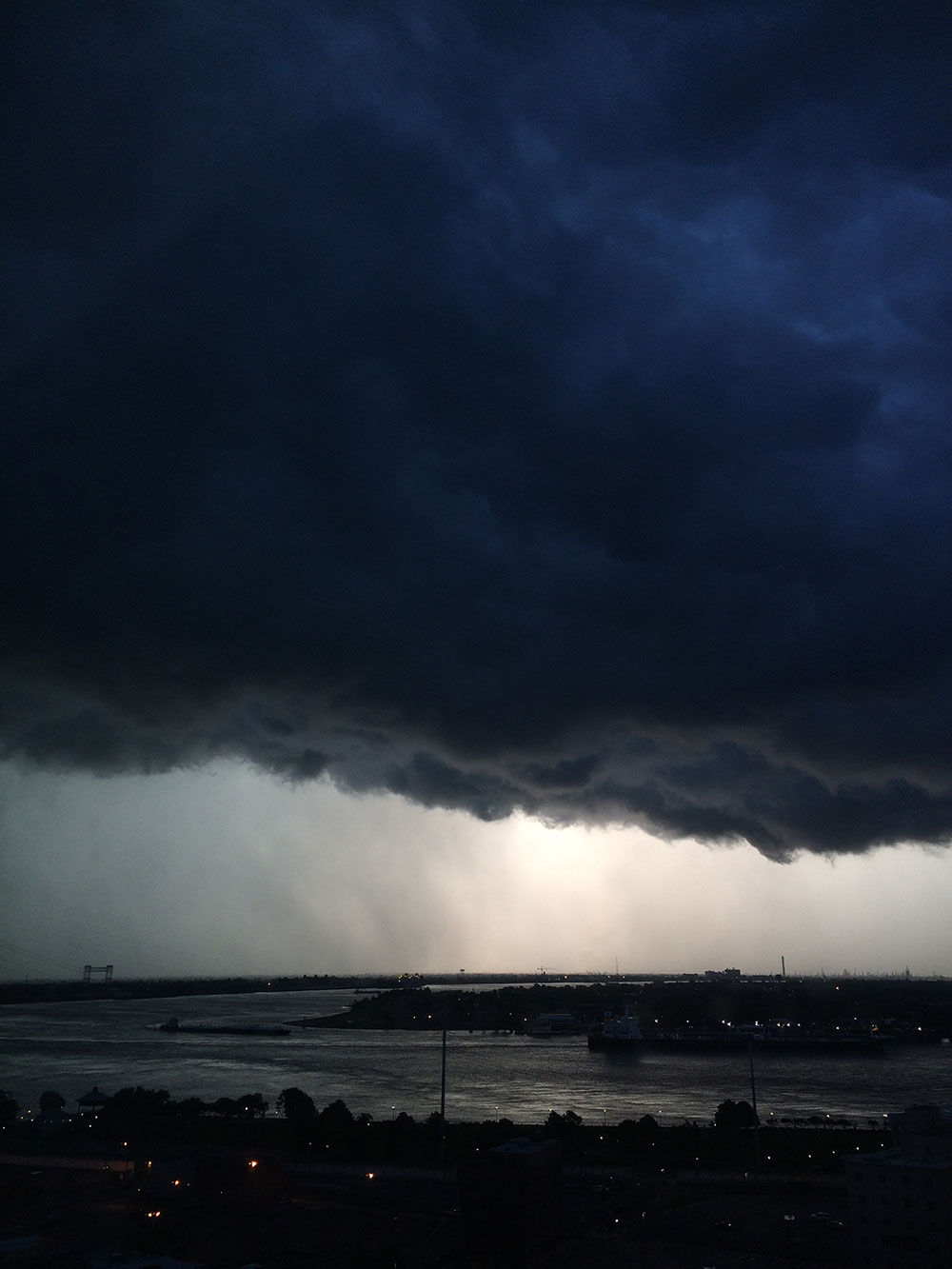 Sunrise peeks out from under a foreboding cloudbank above the Mississippi River in New Orleans, seen from the 19th floor of the Marriott Hotel on Canal St.